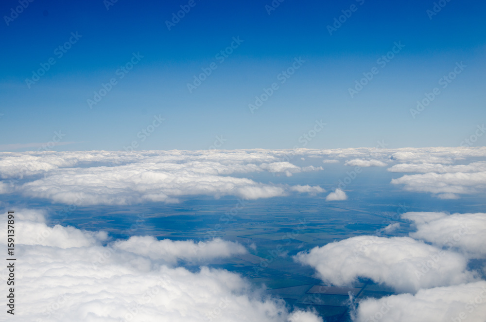 Clouds and sky as seen through window of an aircraft