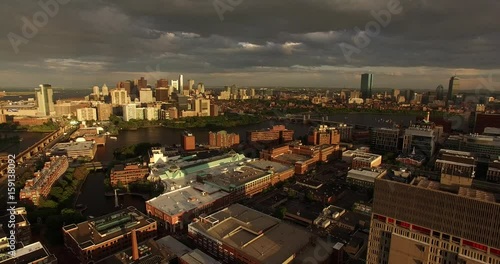 Aerial shot of Boston and Cambridge with Boston downtown and Zakim Bridge in the background during the magic hour sunset photo