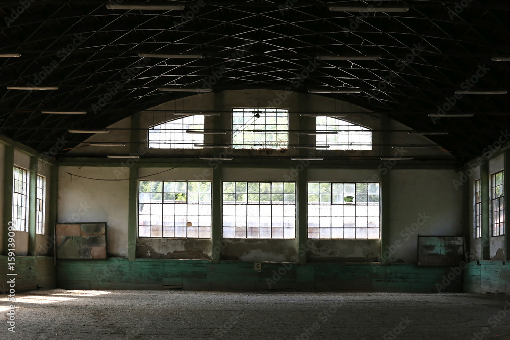 Abandoned riding hall without horses and horsemen