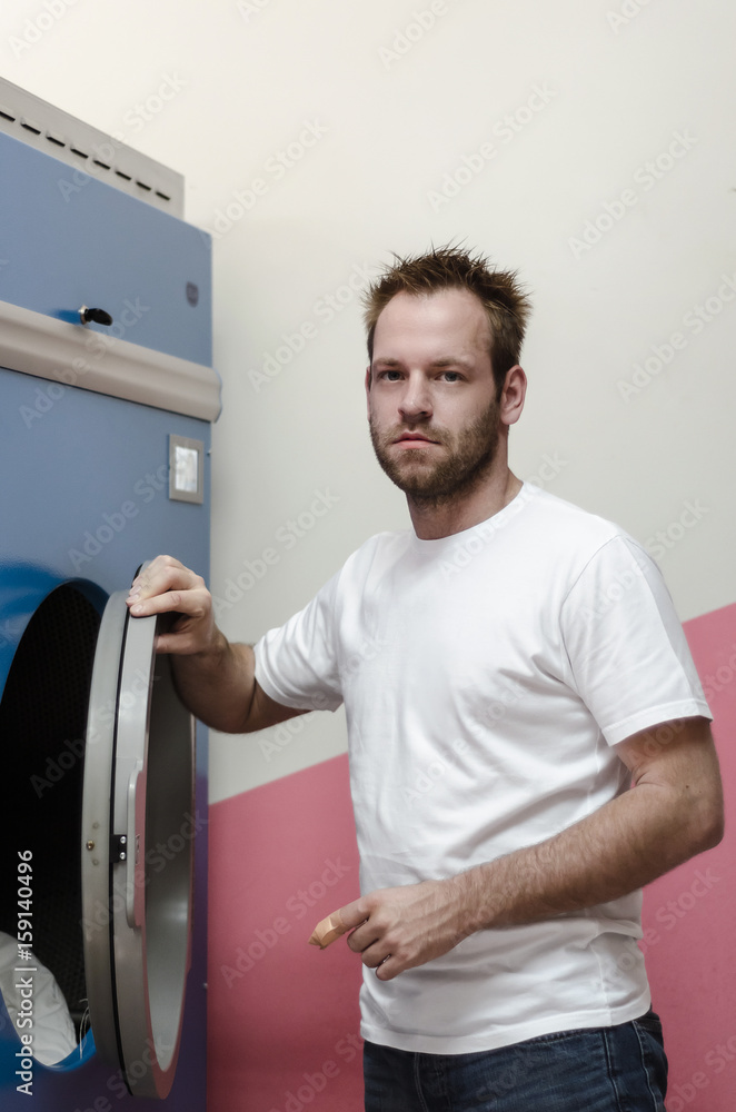 man next to washing machines