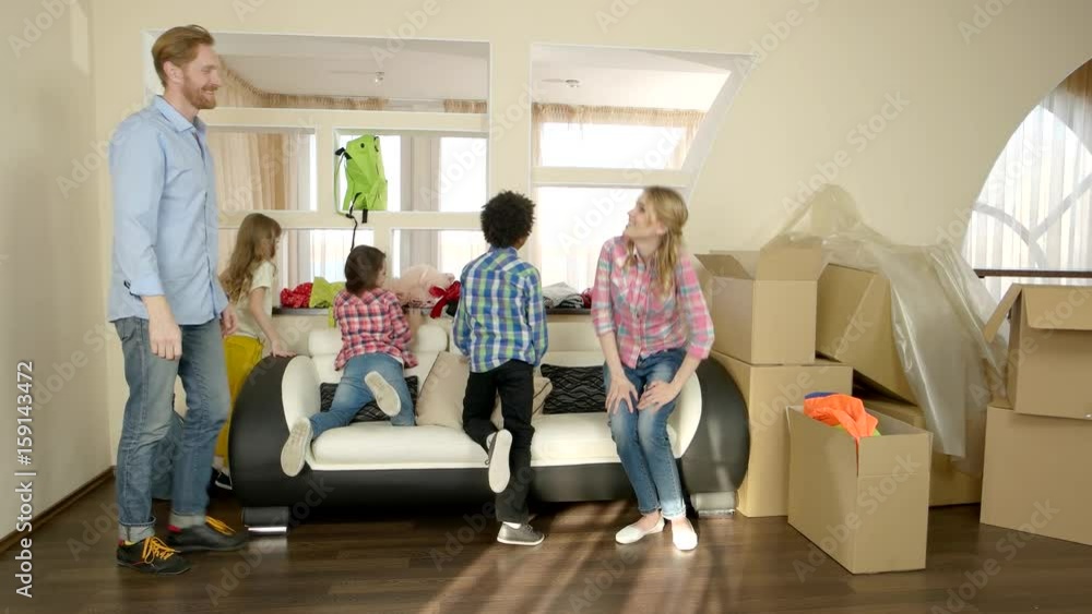 Happy family sitting on couch. Smiling people and cardboard boxes. Life changing tips. Happy family sitting on couch. Smiling people and cardboard boxes. Life changing tips.