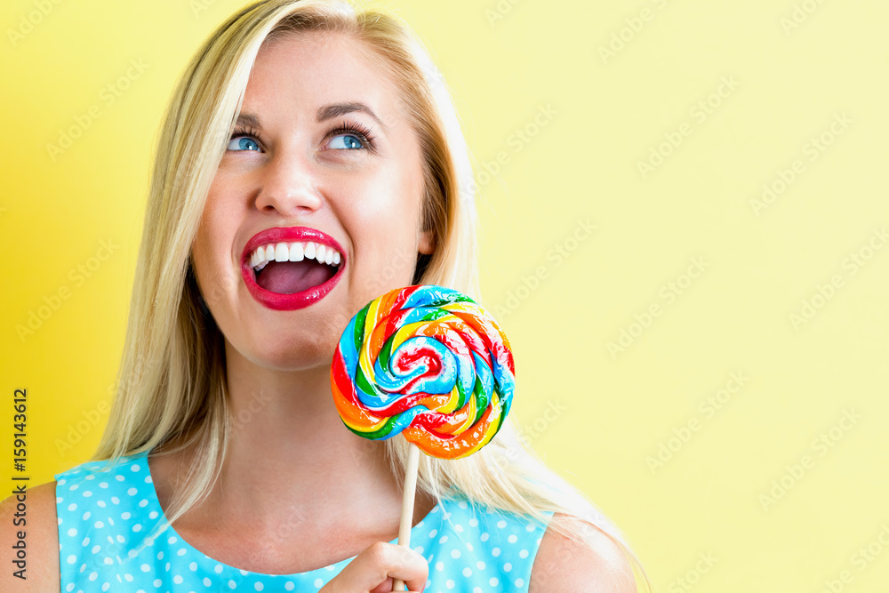 Young woman holding a lollipop