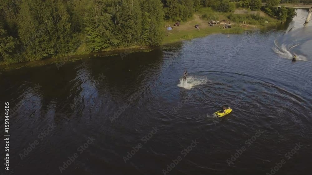 Young girl on the Hover board on the river, water jet spray.Aerial view Girl on the flying board flies over the lake water.Aerial video.4K video. Young girl on the Hover board on the river, water jet spray.Aerial view Girl on the flying board flies over the lake water.Aerial video.4K video.