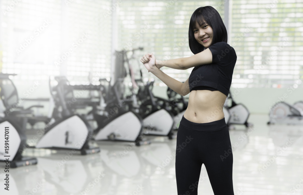 Beautiful women working out in blurry gym background. Beautiful women working out in blurry gym background.