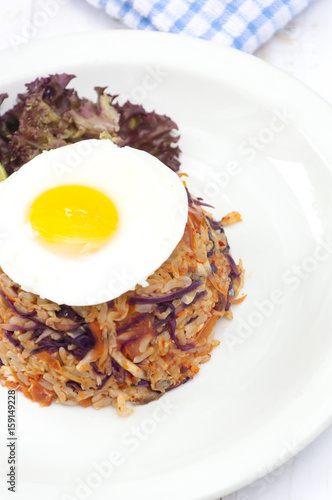 Fried rice with chili shrimp dip and mackerel on wood in garden background.