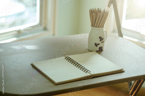 reading writing drawing thinking working with a note book in the morning room with sunshine