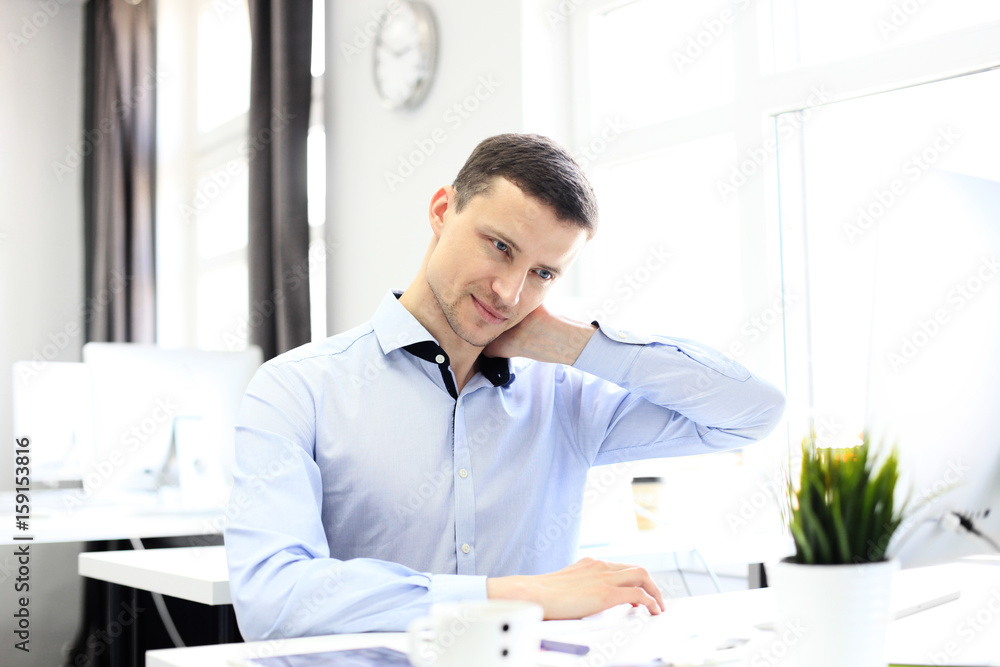 Portrait of a delighted businessman relaxing in his office. Portrait of a delighted businessman relaxing in his office.