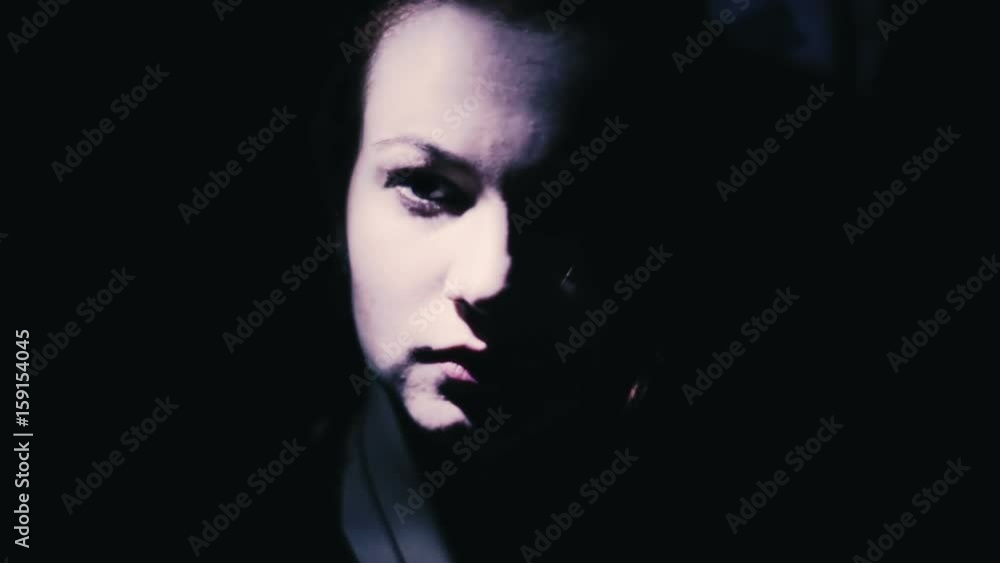 Face of a beautiful girl in the dark close-up Face of a beautiful girl in the dark close-up
