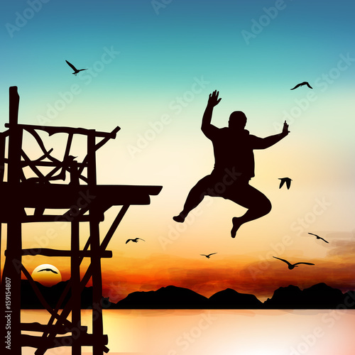 Silhouette and jumping girl in the twilight with blue sky.