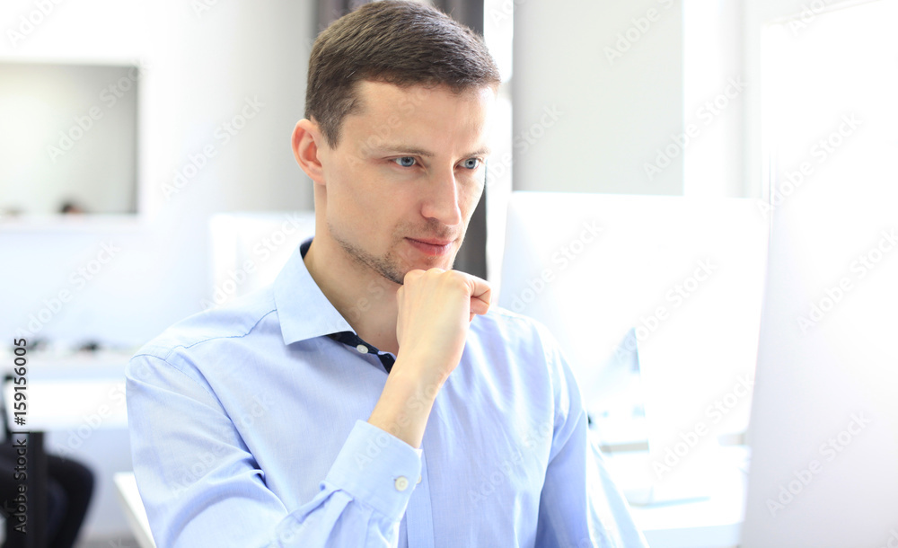 Elegant businessman analyzing data in the office. Elegant businessman analyzing data in the office.