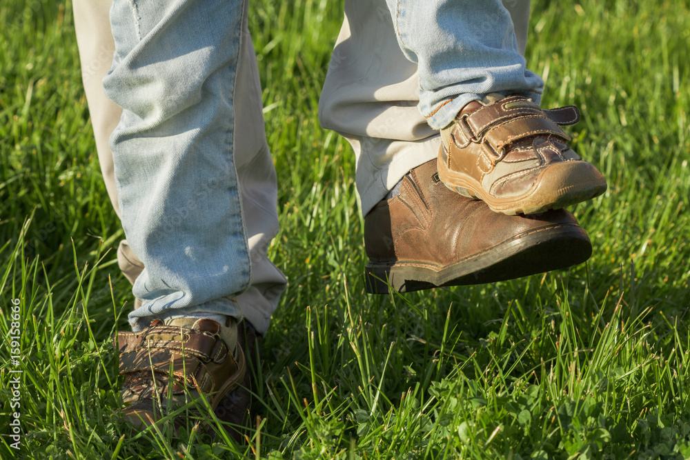 Father and son playing in the park at the day time. Concept of parenting and family. Father and son playing in the park at the day time. Concept of parenting and family.