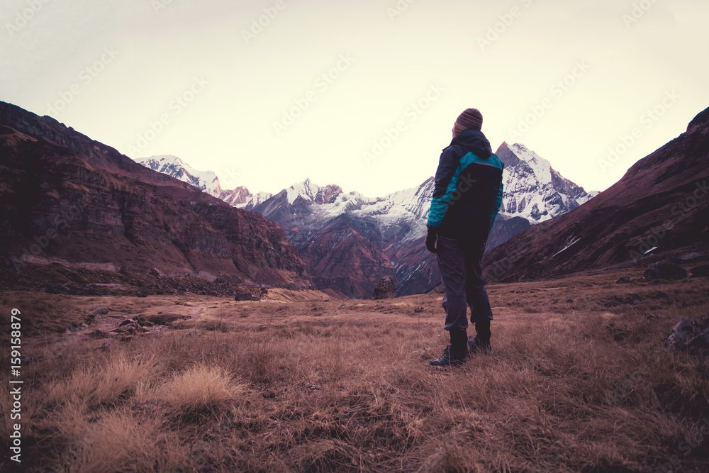 Man standing and looking at view of the mountains Man standing and looking at view of the mountains