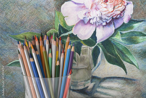 A bunch of colored pencils on the background of a drawing with colored pencils