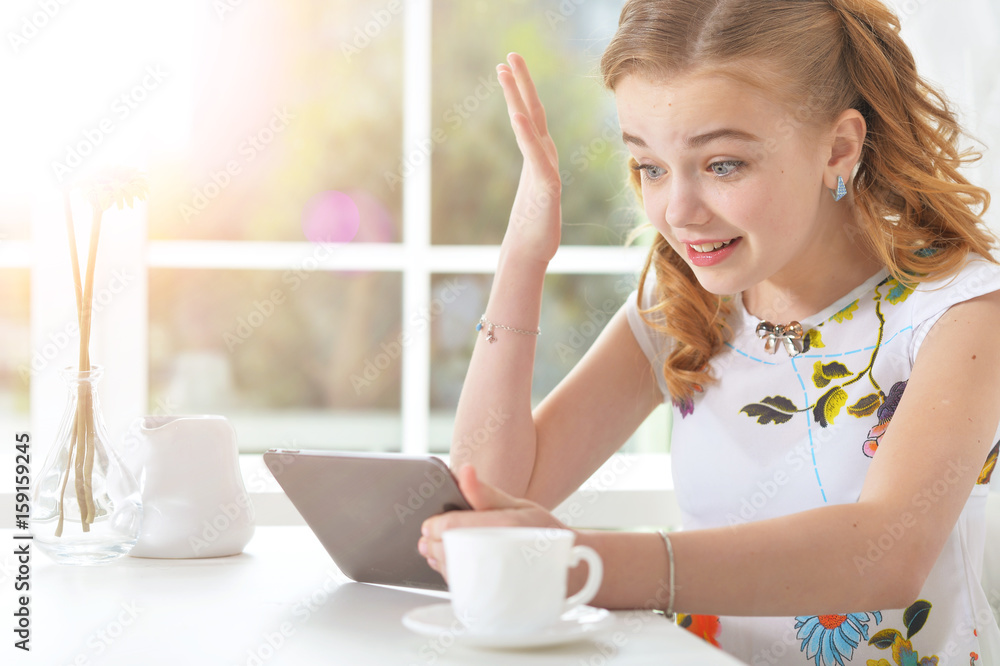Surprised little girl looking at tablet Surprised little girl looking at tablet