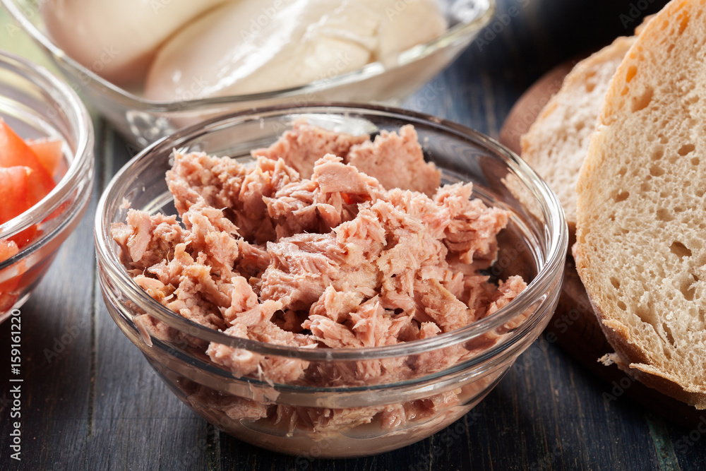Ingredients ready for preparing bruschetta with tuna, mozzarella cheese and tomatoes