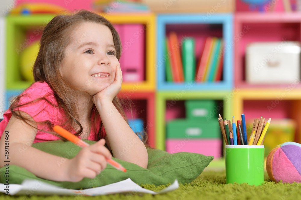 little girl in pink shirt drawing