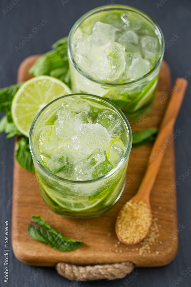 Mojito and ingredients, dark background Mojito and ingredients, dark background