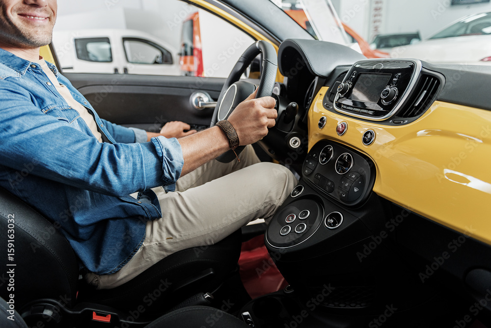 Joyful male sitting in car Joyful male sitting in car