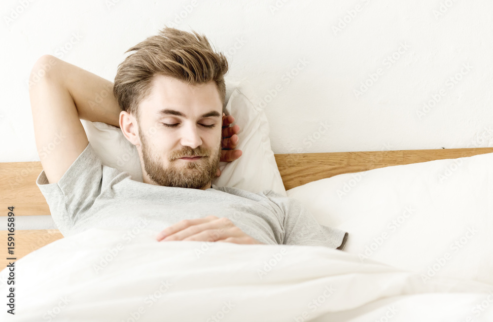 Men sleep on bed in the morning with in badroom Men sleep on bed in the morning with in badroom