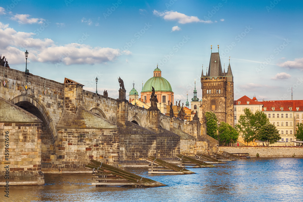 Prague, Czech Republic famous view with historic Charles Bridge and Vltava river during nice summer day