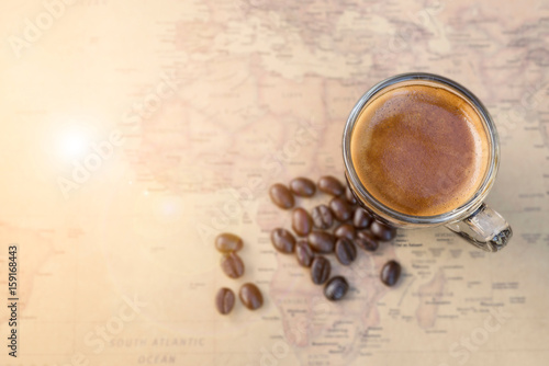 Black coffee with bean on world map background