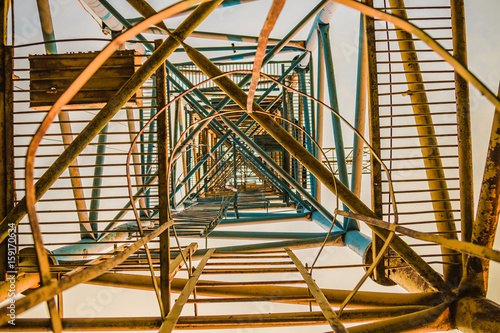 Old rusty abandoned building gantry crane on rusty rails. photo