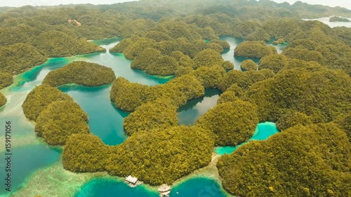 Aerial view: Bucas Grande Island, Sohoton Cove. Philippines. Tropical sea bay and lagoon, beach. Tropical landscape hill, clouds and mountains rocks with rainforest. Azure water of lagoon. Shore photo