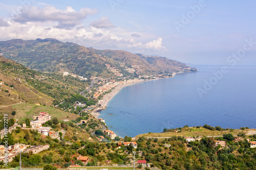 View of the coast of the Ionian Sea and the bay of Giardini Naxos from Teatro Greco - Taormina, Sicily, Italy