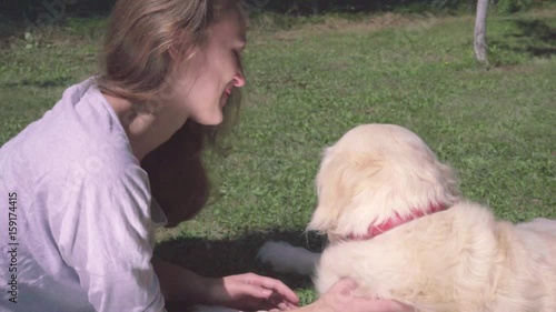 Attractive happy woman carries golden retrver - dog licks her face - friends