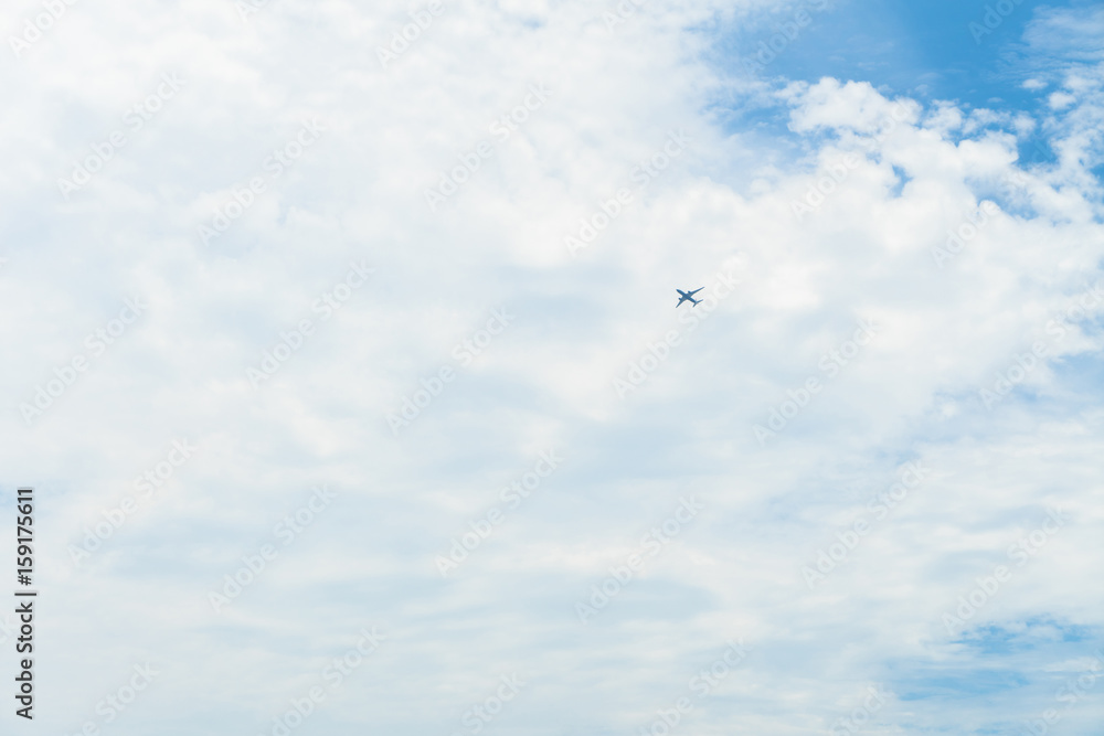 The plane is flying through clouds in the sky.