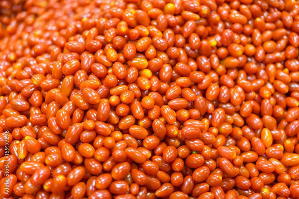 Small tomatoes stack together in a lot of fruit and vegetable shops. Small tomatoes stack together in a lot of fruit and vegetable shops.