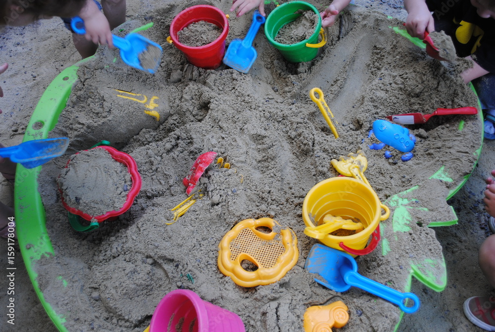 Children's beach toys - buckets, spade and shovel on sand on a sunny day