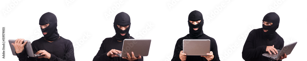 Hacker with computer wearing balaclava Hacker with computer wearing balaclava