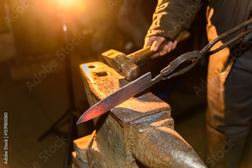 Fototapeta Forging molten metal. Making knives.