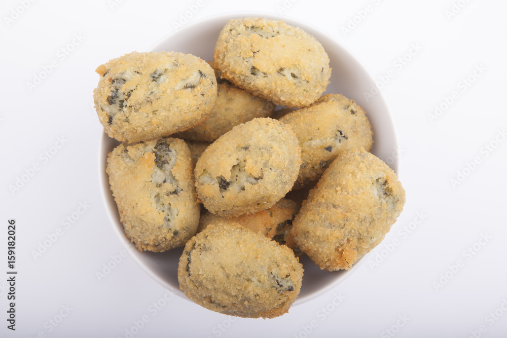 a handful of homemade croquettes of spinach isolated on white a handful of homemade croquettes of spinach isolated on white