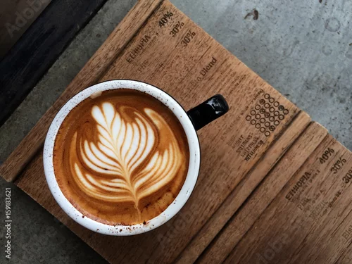 Obraz Nice Texture of Latte art on hot latte coffee . Milk foam in heart shape leaf tree on top of latte art from professional barista artist