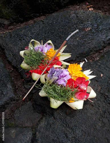 Traditional Balinese flower offerings to the Hindu God with incense.