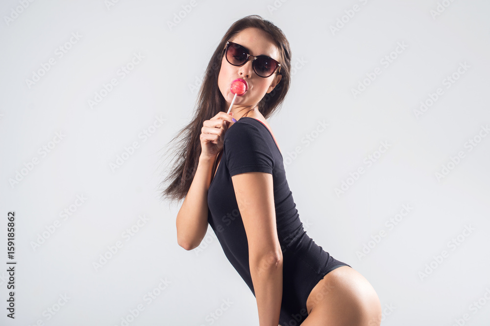 Young brunette model with lollipop studio shot on white background, not isolated Young brunette model with lollipop studio shot on white background, not isolated