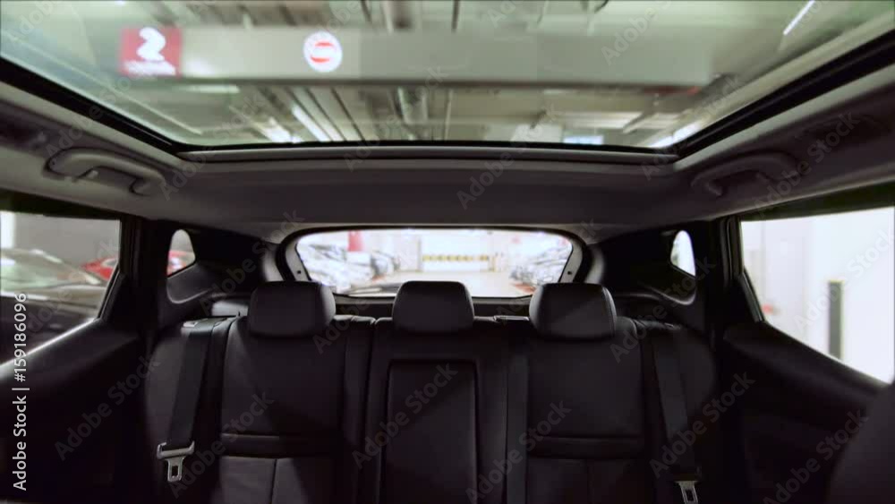 Outdoor glass roof top car cabin. Driving in indoor carpark. Generic 5