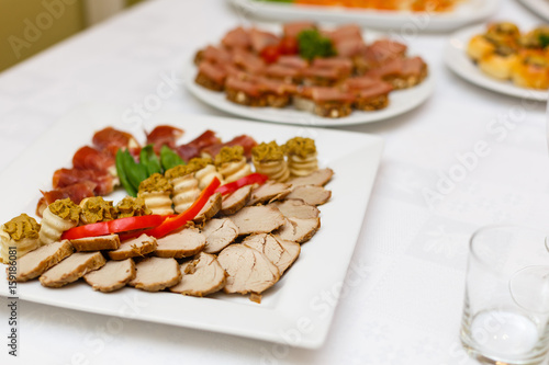 Delicious buffet table at a luxury event spread with a variety of cold meat platters and fresh colorful salad and vegetables