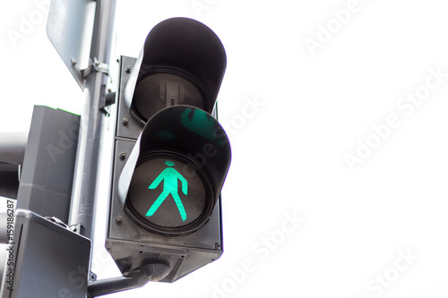 Traffic lights with the green light lit for pedestrians. Isolated on white