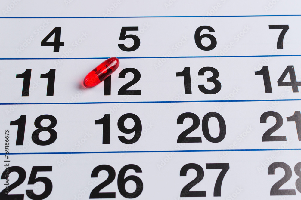 Red pill on the calendar. Schedule medication Red pill on the calendar. Schedule medication