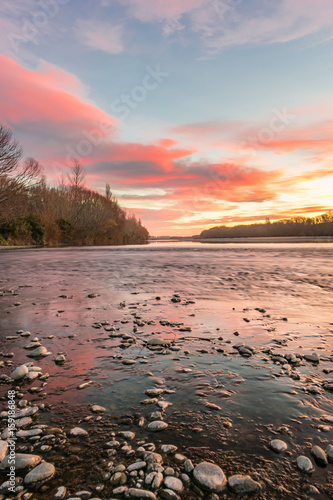 Stunning view of the sunset on Waimakariri river photo