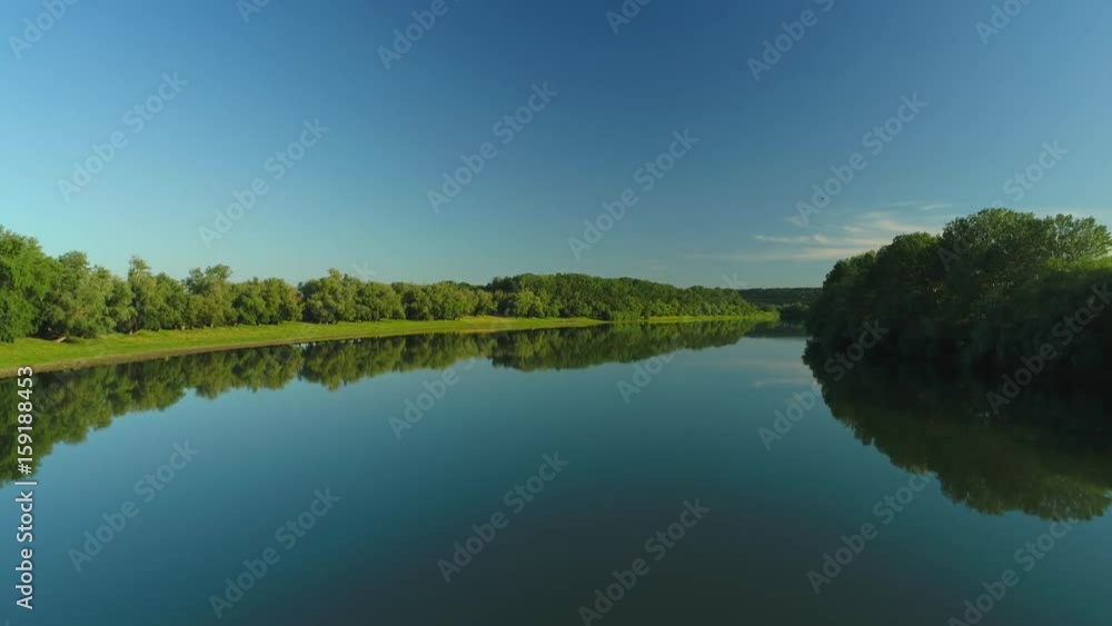 Aerial video of a quiet river and blue sky reflecting in it Aerial video of a quiet river and blue sky reflecting in it