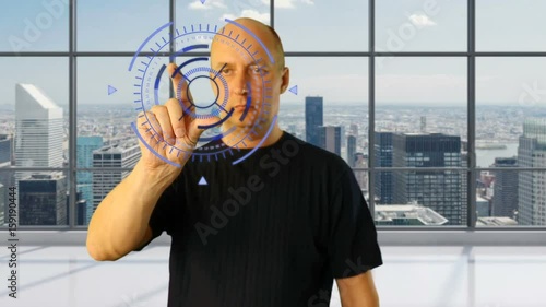 Adult man in modern office work with virtual screen. Shureshki rotation. Gestures on touchscreen zoom touch swipe pinch. Sci-fi techno animation HUD GUI interface. Modern technology fituristic designe photo