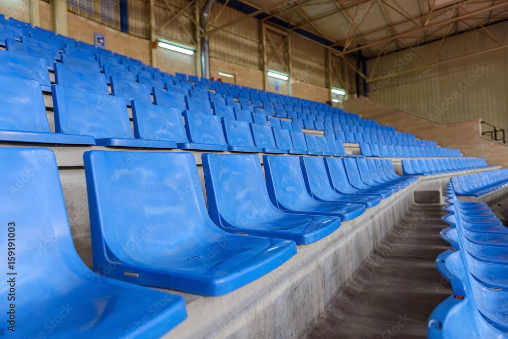Fototapeta premium blue plastic seats in a sports hall in a row