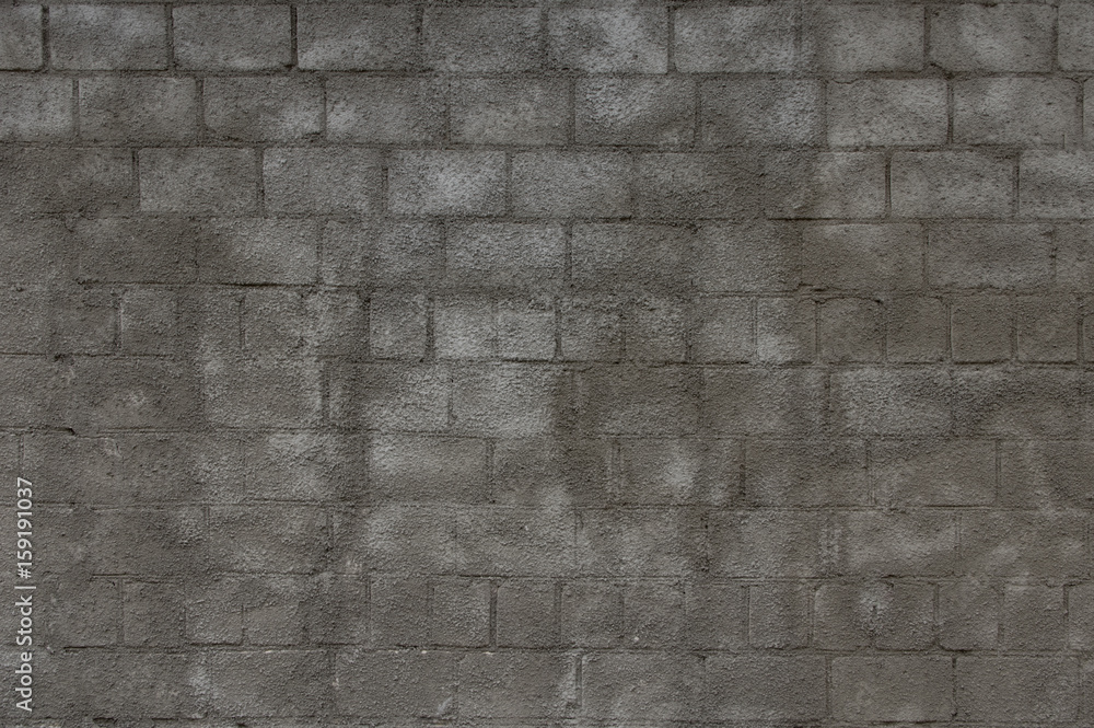 Fototapeta premium Gray with decorative plaster brick wall.