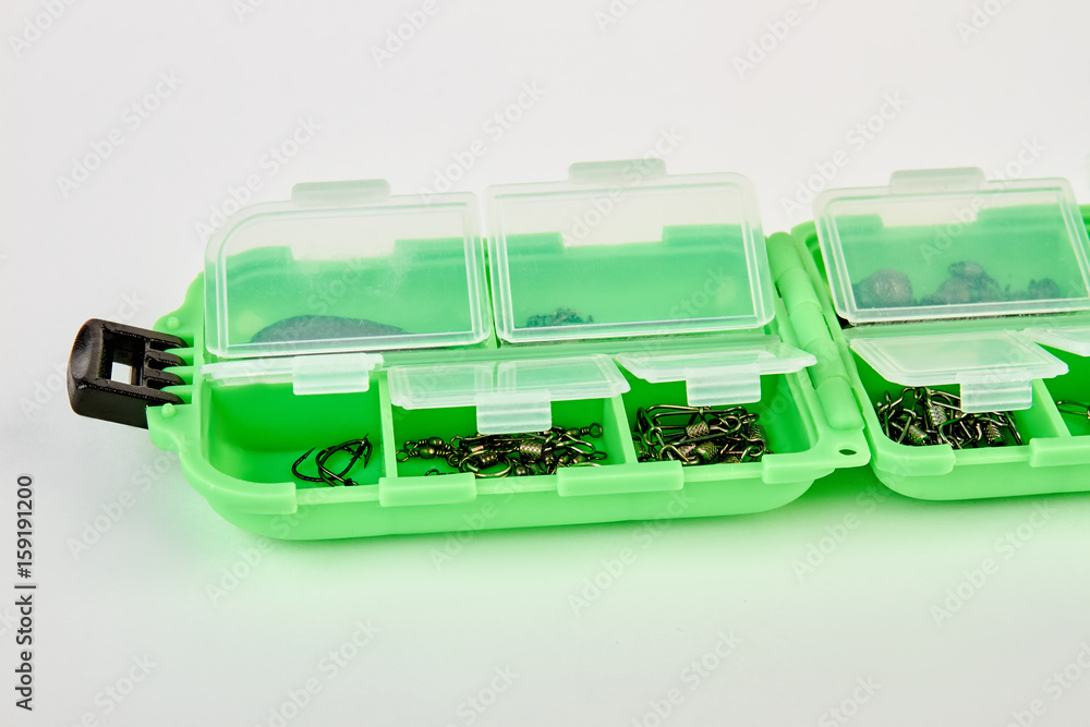Opened box with fishing hooks. Fishing hooks in box sections. Case for tackle elements. Opened box with fishing hooks. Fishing hooks in box sections. Case for tackle elements.