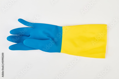 Yellow blue rubber glove isolated. Colorful latex glove on white background.