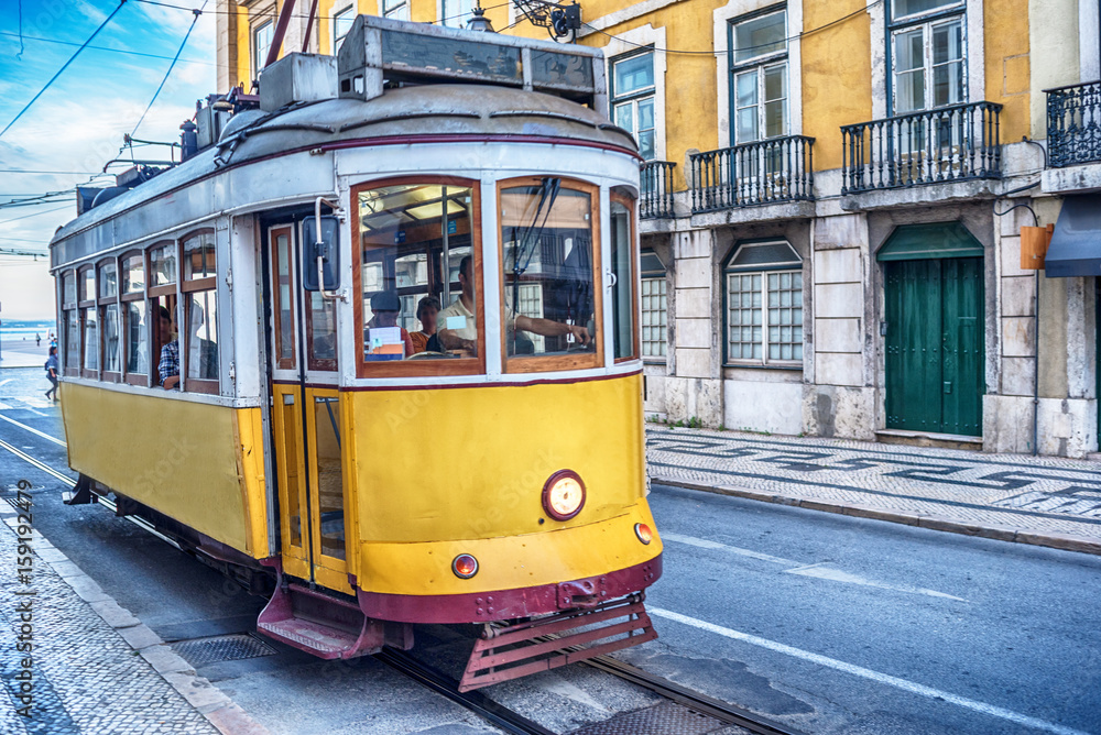 Lisbon, Portugal: the tram in the old town at sunrise 
